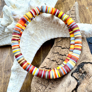 All Up In The Hair | Online Accessory Boutique Located in Mooresville, NC | Two heishi bracelets with traditional autumn colors laying on a piece of driftwood and a white starfish.