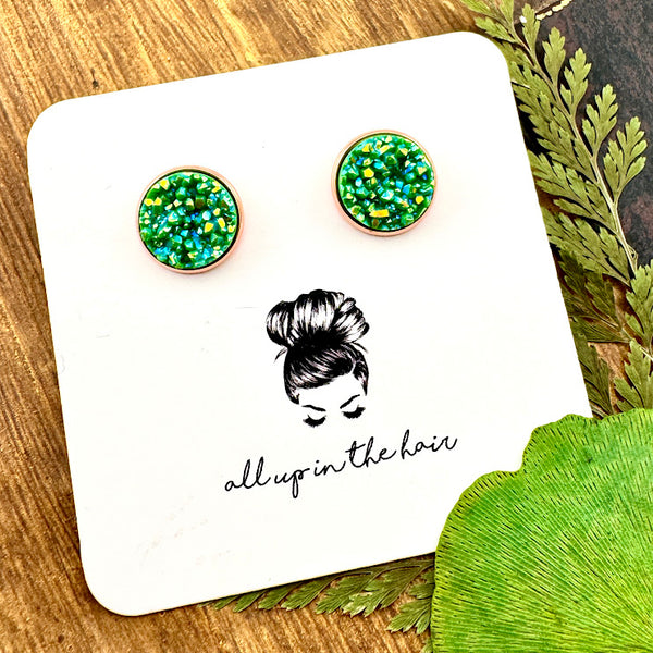 All Up In The Hair | Online Accessory Boutique Located in Mooresville, NC | Two Aventurine Druzy set in a rose gold stud. The earrings are on a white, All Up In The Hair branded packging card. The card is laying on a wood background alongside green leaves.