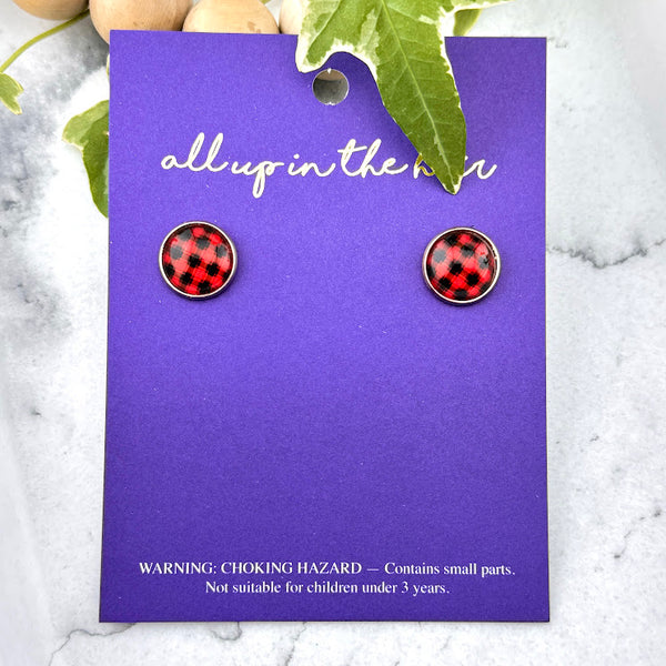 All Up In The Hair | Online Accessory Boutique Located in Mooresville, NC | Two Buffalo Plaid Earrings on an indigo colored, All Up In The Hair branded packaging card. The card is laying on a white marble background. 