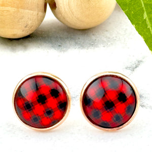 All Up In The Hair | Online Accessory Boutique Located in Mooresville, NC | Two Buffalo Plaid Earrings on a white marble background. Behind the earrings is a wood bead garland and ivy leaves.