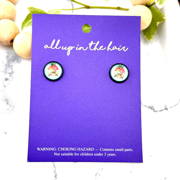 All Up In The Hair | Online Accessory Boutique Located in Mooresville, NC | Two Chillin' Skeleton Earrings on an indigo colored, All Up In The Hair branded packaging card. The card is laying on a white marble background.
