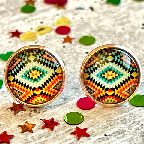 All Up In The Hair | Online Accessory Boutique Located in Mooresville, NC | Two Comin' Out The Southwest Earrings laying on a gray background, surrounded by colorful glitter.