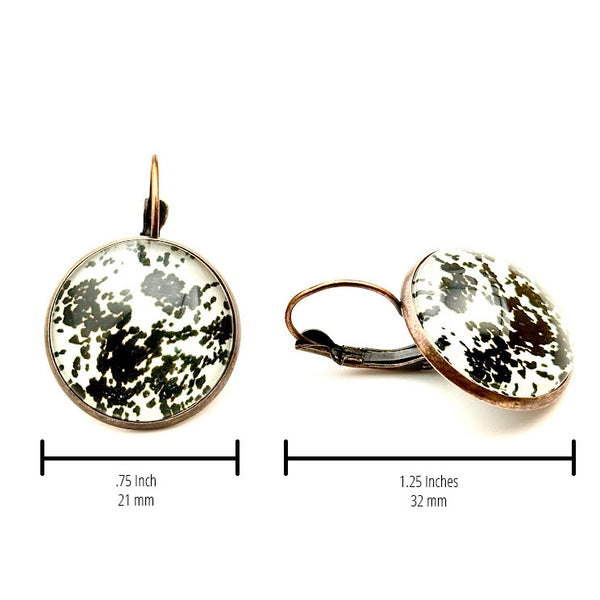 All Up In The Hair | Online Accessory Boutique Located in Mooresville, NC | Two Cow Hide Print Dangle Earrings on a plain white background. The measurements of the earrings are written underneath each earring.