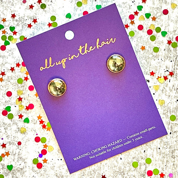 All Up In The Hair | Online Accessory Boutique Located in Mooresville, NC | Two dark marble earrings on an All Up In The Hair branded packaging card. The card is laying on a gray background, surrounded by colorful glitter.