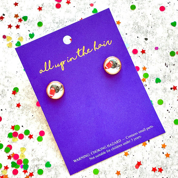 All Up In The Hair | Online Accessory Boutique Located in Mooresville, NC | Two football earrings on an All Up In The Hair branded packaging card. The card is laying on a gray background, surrounded by colorful glitter.
