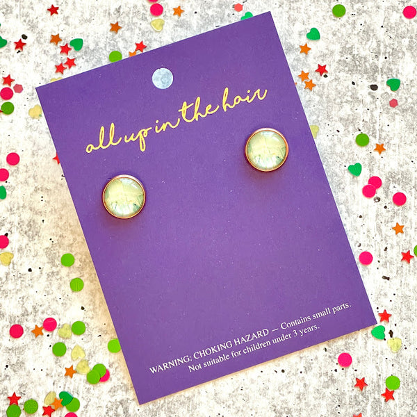 All Up In The Hair | Online Accessory Boutique Located in Mooresville, NC | Two light marble earrings on an All Up In The Hair branded packaging card. The card is laying on a gray background, surrounded by colorful glitter.