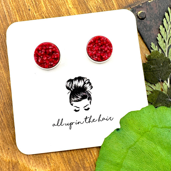 All Up In The Hair | Online Accessory Boutique Located in Mooresville, NC | Two Maroon Druzy in silver settings on a white, All Up In The Hair branded packaging card. The card is laying on a wood background next to green leaves.