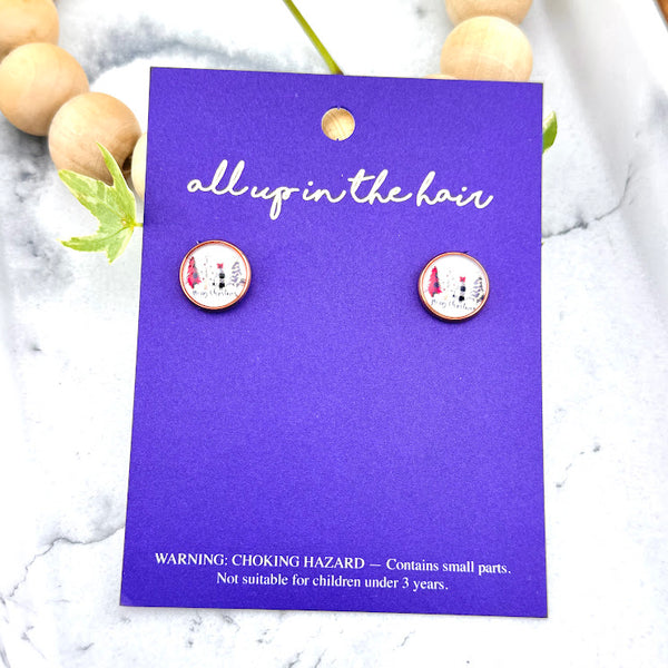 All Up In The Hair | Online Accessory Boutique Located in Mooresville, NC | Two Merry Christmas Earrings on an indigo colored, All Up In The Hair branded packaging card. The card is laying on a white marble background.