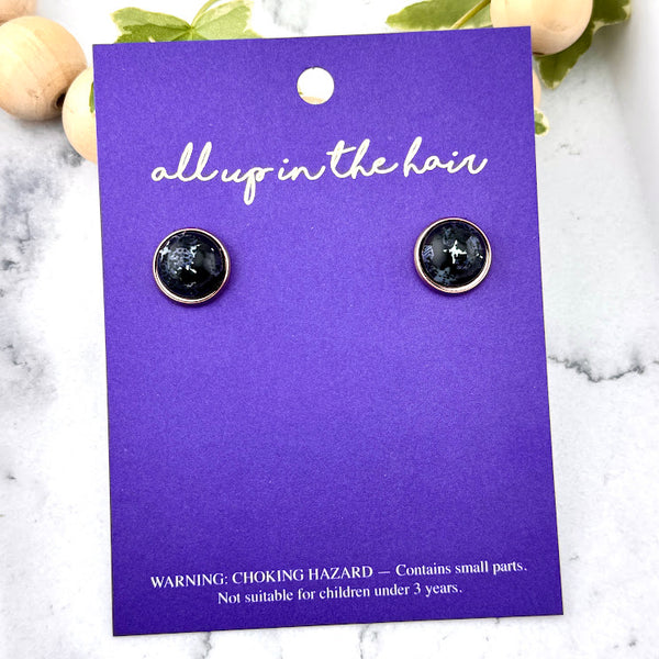 All Up In The Hair | Online Accessory Boutique Located in Mooresville, NC | Two Nova Stud Earrings on an indigo colored, All Up In The Hair branded packaging card. The card is laying on a white marble background.