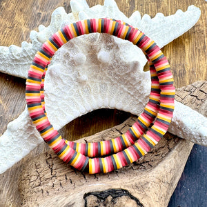 All Up In The Hair | Online Accessory Boutique Located in Mooresville, NC | Two bracelets with a retro yellow/burgundy/grey color palette laying on a piece of driftwood and a white starfish.