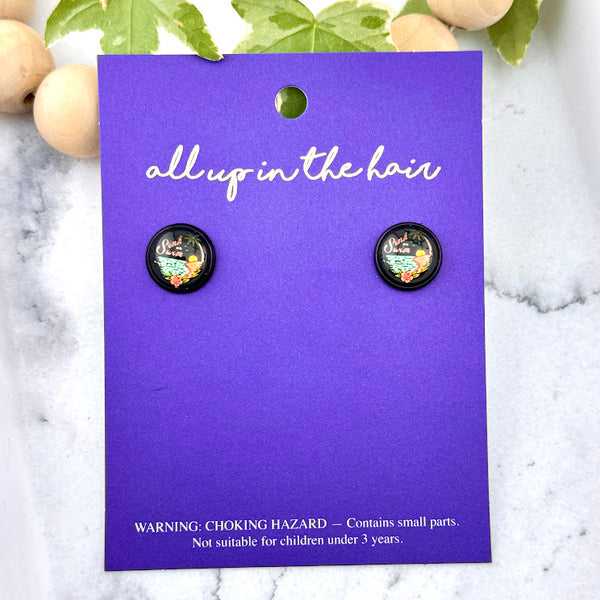 All Up In The Hair | Online Accessory Boutique Located in Mooresville, NC | Two Sink Or Swim Skeleton Earrings on an indigo colored, All Up In The Hair branded packaging card. The card is laying on a white marble background.