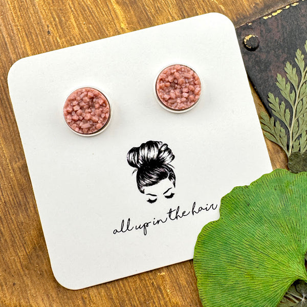 All Up In The Hair | Online Accessory Boutique Located in Mooresville, NC | Two taupe druzies set in a silver earring setting. The earrings are on a white, All Up In The Hair branded packaging card. The card is on a wood background alongside green leaves.