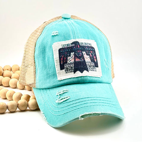 All Up In The Hair | Online Accessory Boutique Located in Mooresville, NC | A blue baseball cap with a geometric thunderbird patch on a white background.